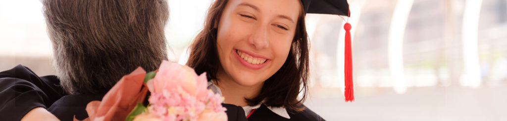 graduation student hugging family member